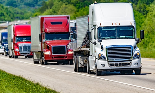 Semi trucks driving down the road